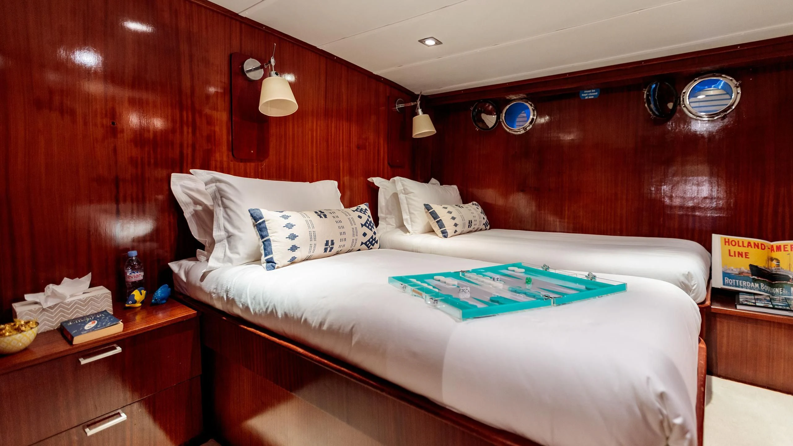 a bed with a board game on it aboard VITA DOLCE Yacht for Sale