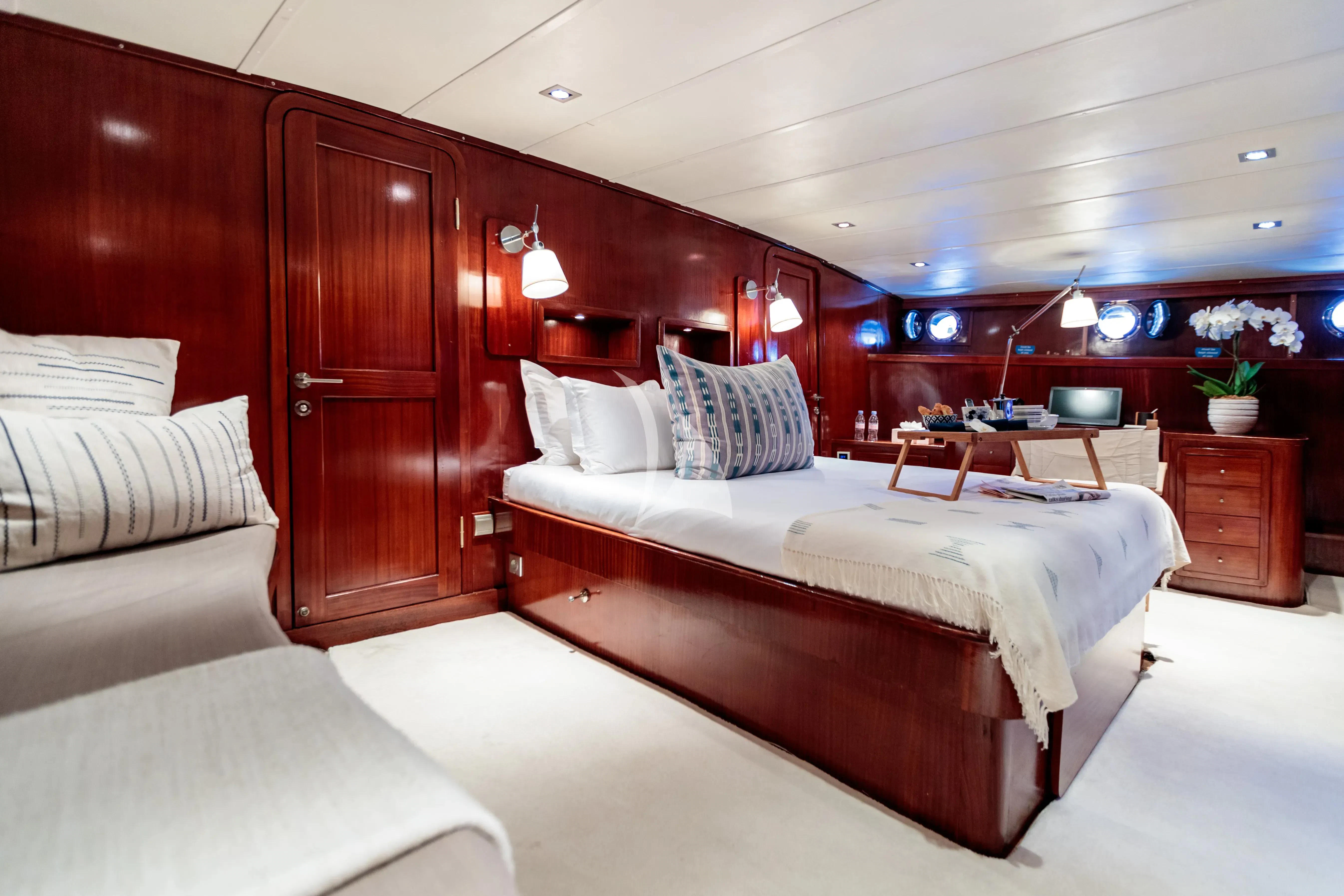 a room with a bed and a desk aboard VITA DOLCE Yacht for Sale