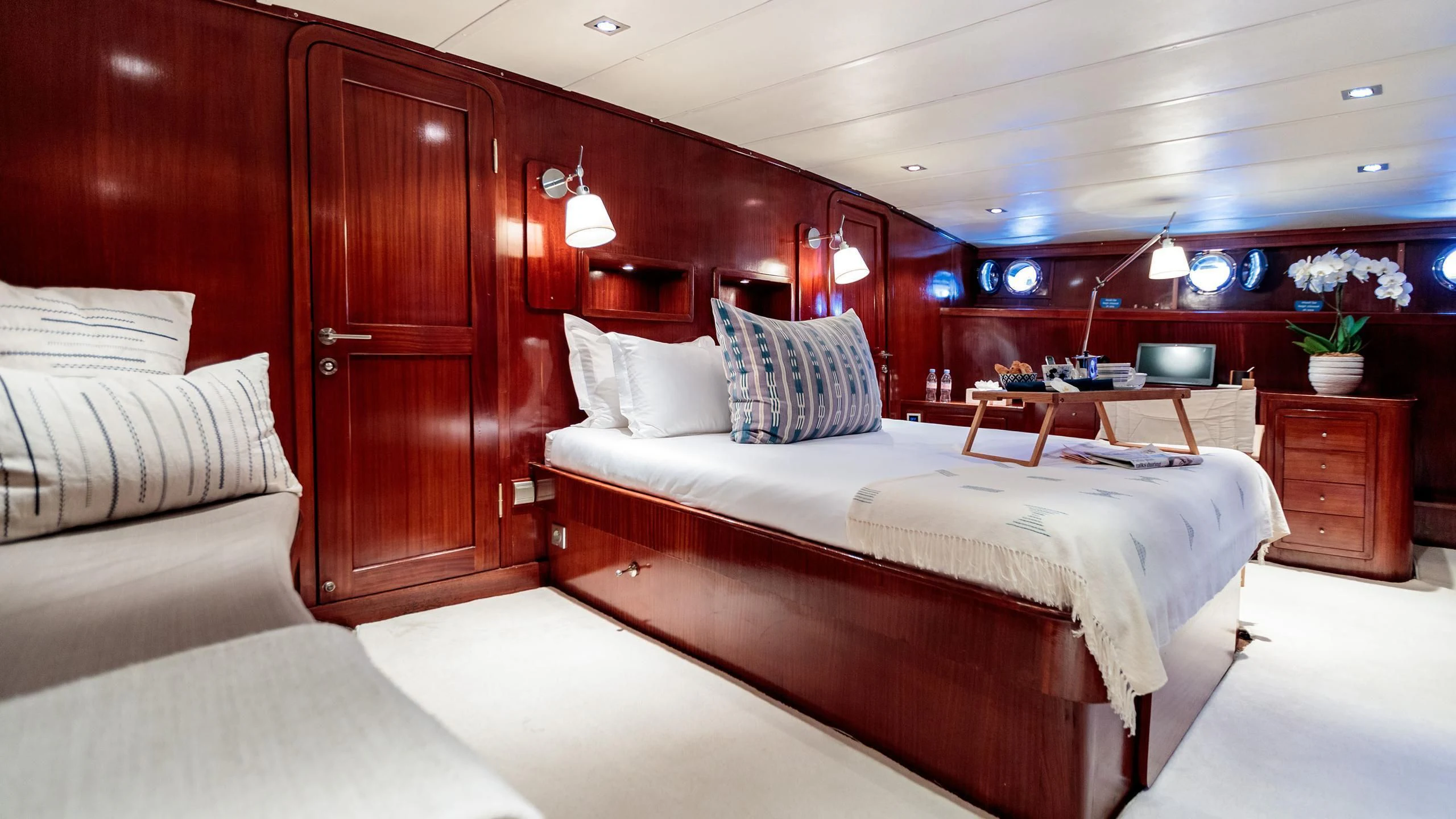 a room with a bed and a couch aboard VITA DOLCE Yacht for Sale