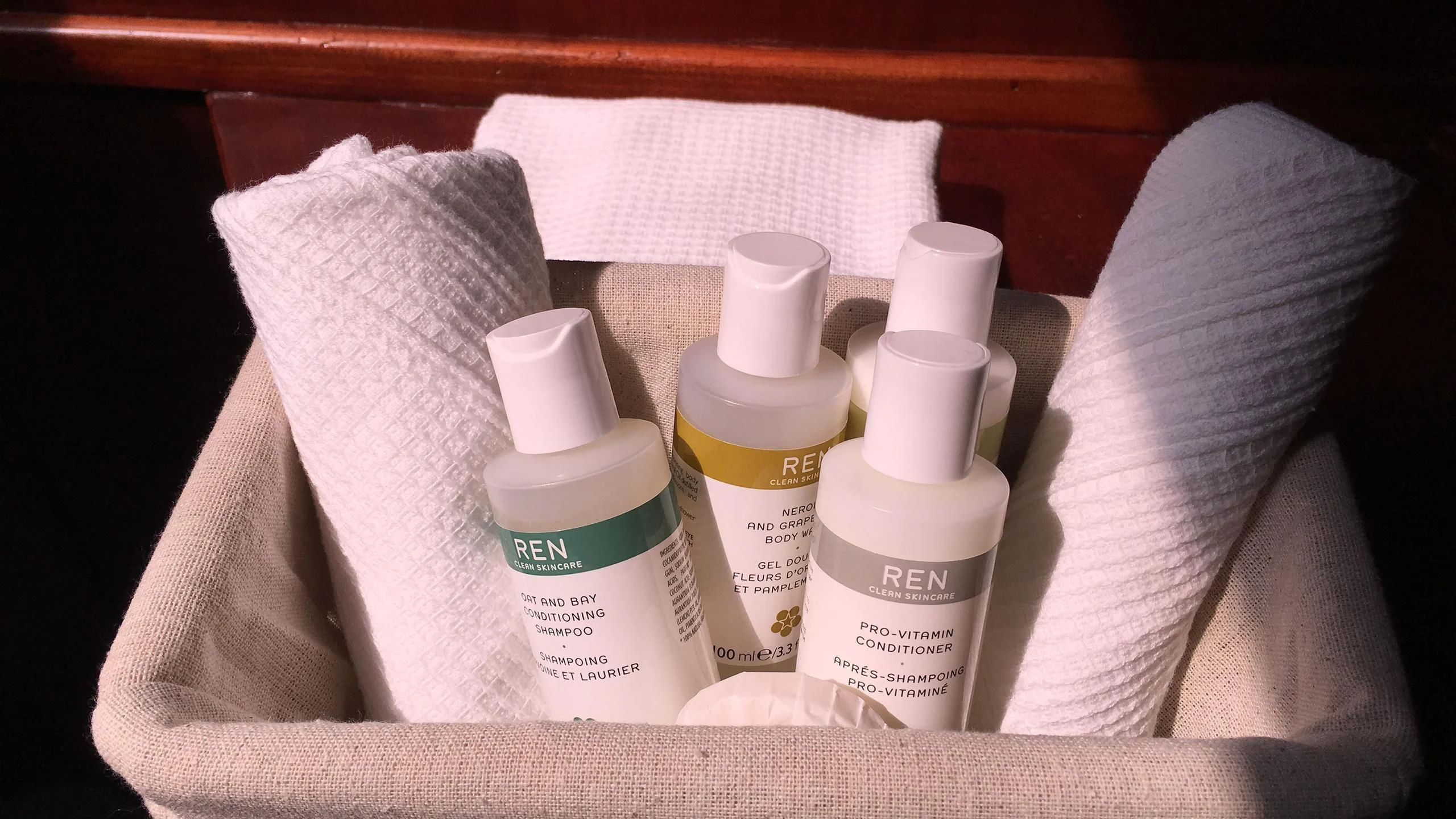 a person's hand with a towel and a bottle of shampoo aboard VITA DOLCE Yacht for Sale