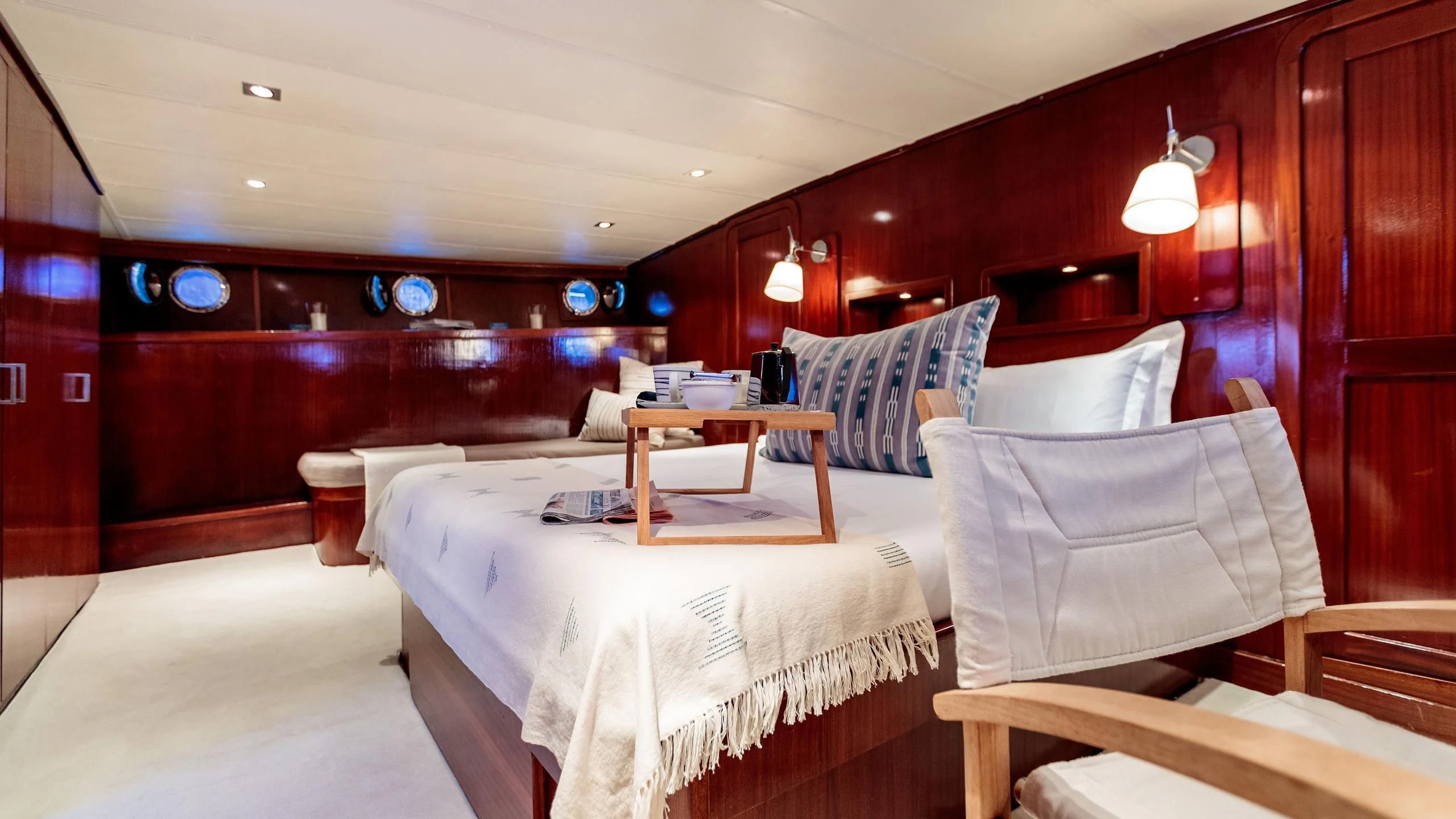 a room with beds and a table aboard VITA DOLCE Yacht for Sale
