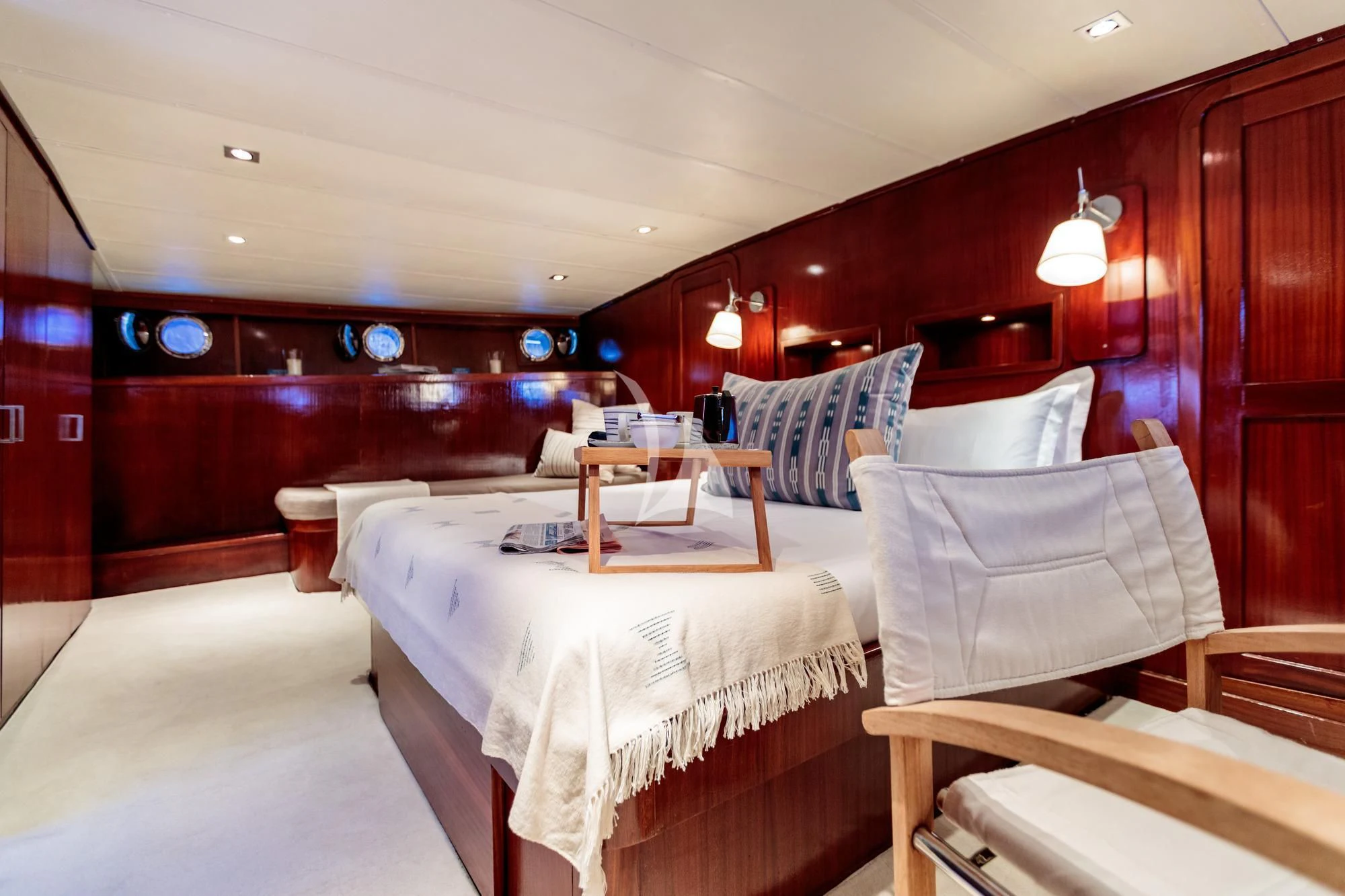 a room with beds and chairs aboard VITA DOLCE Yacht for Sale
