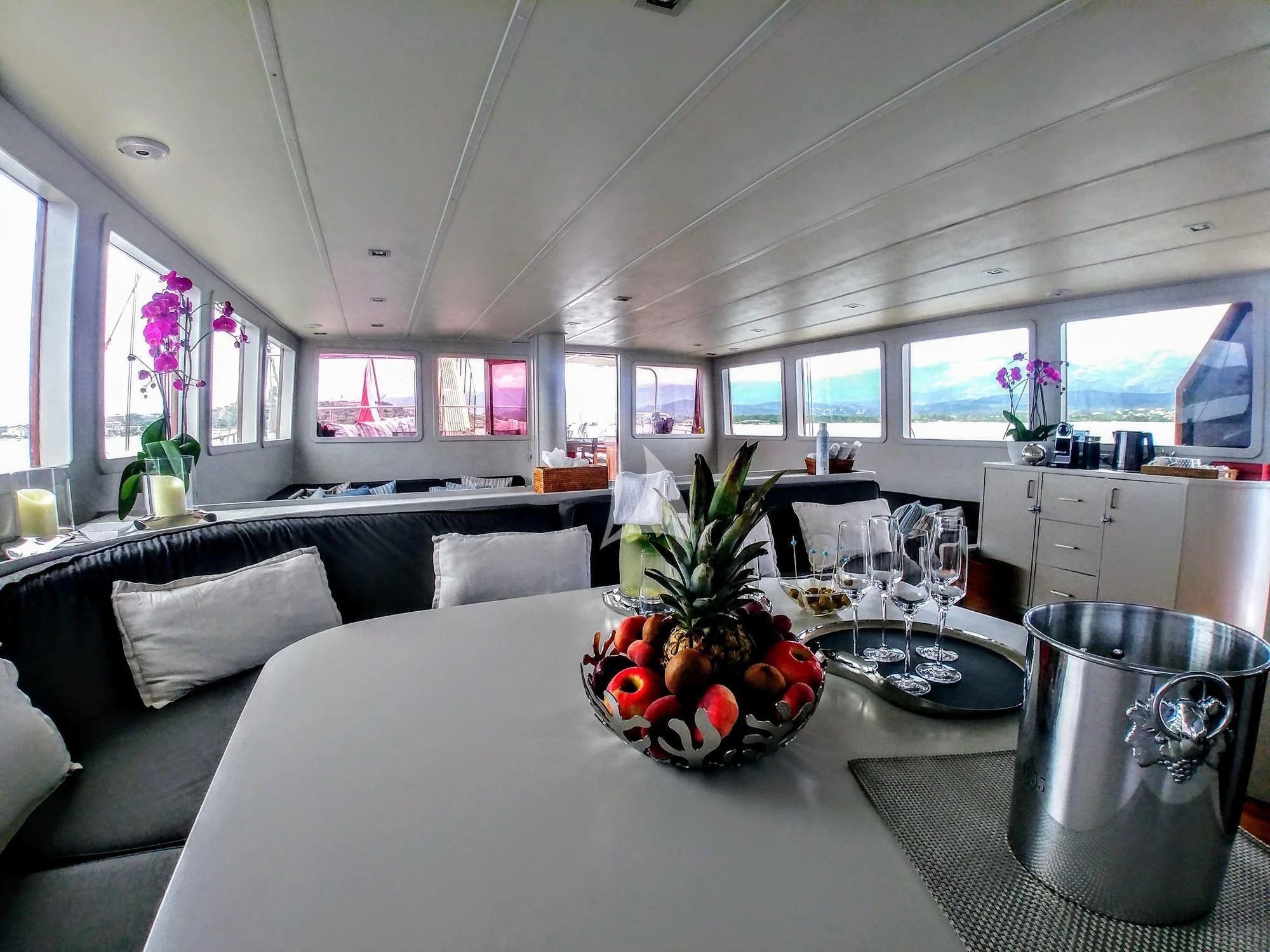 a living room with a table and chairs aboard VITA DOLCE Yacht for Sale