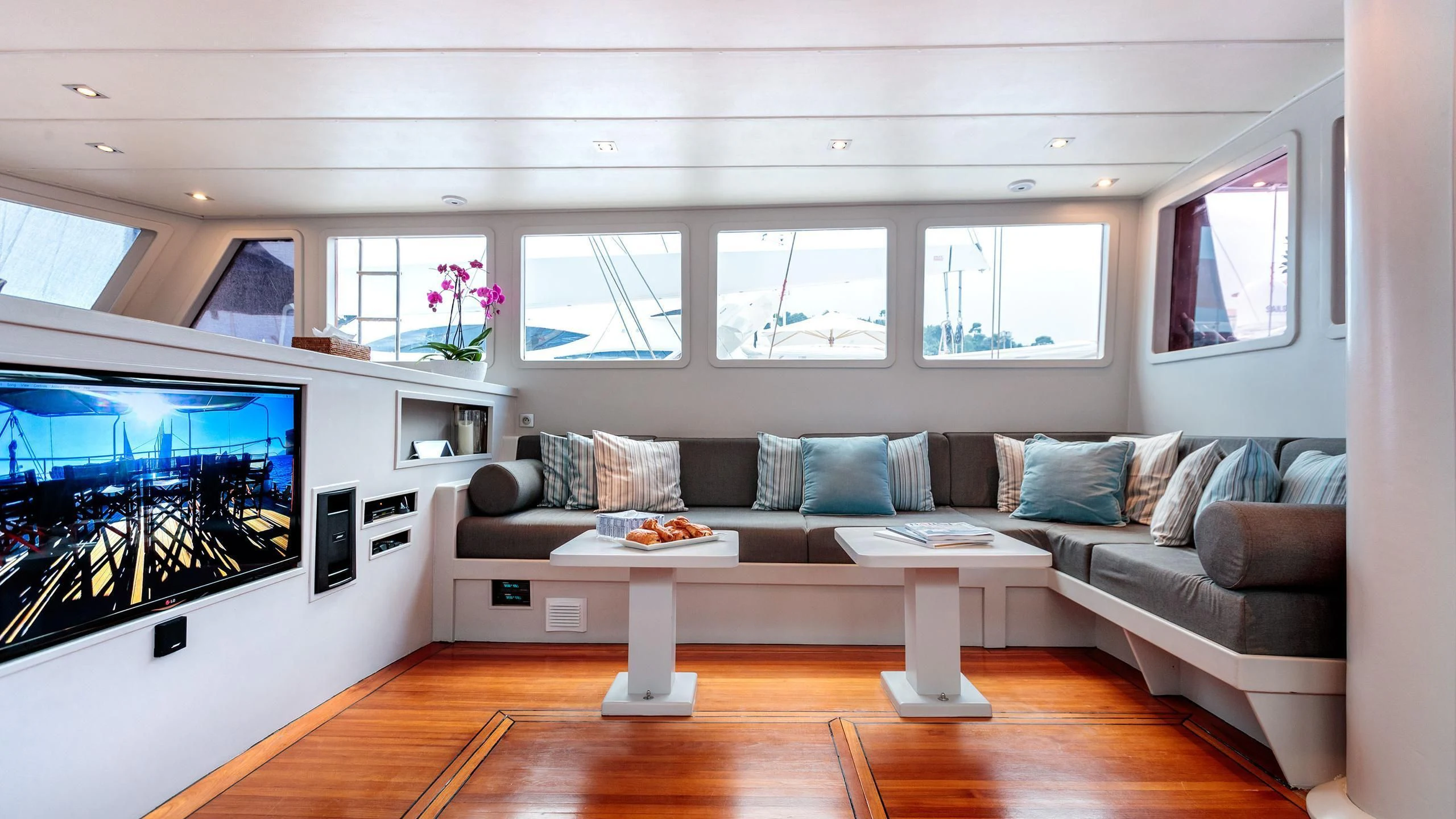 a living room with a large screen aboard VITA DOLCE Yacht for Sale