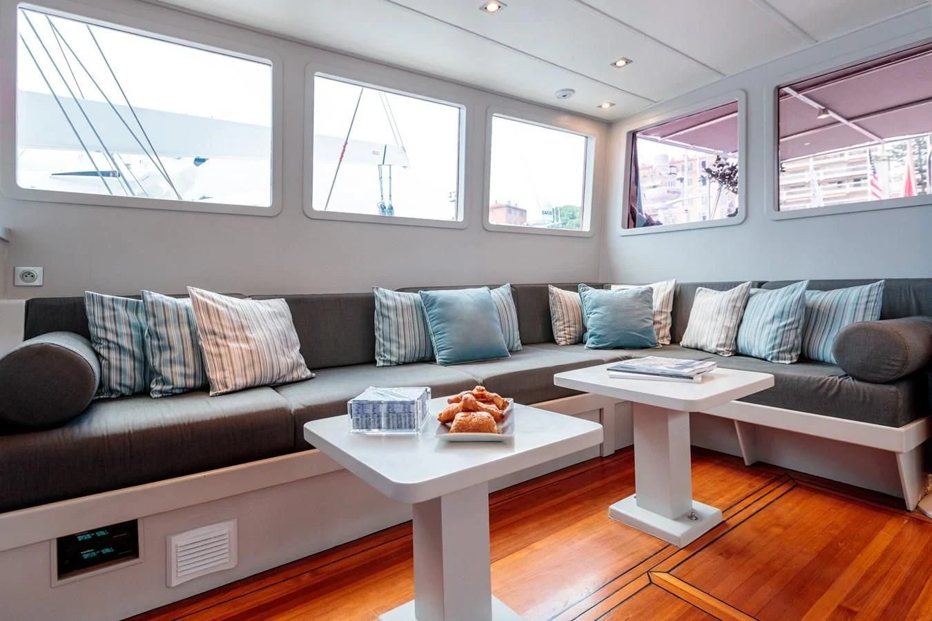 a living room with a couch and a coffee table aboard VITA DOLCE Yacht for Sale