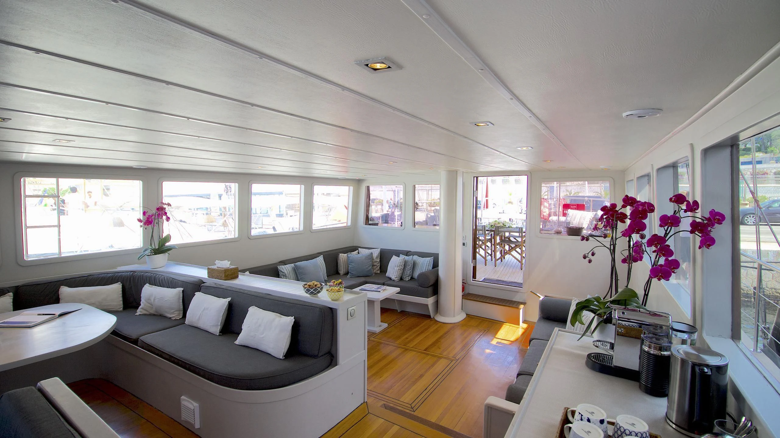a living room with a large window aboard VITA DOLCE Yacht for Sale