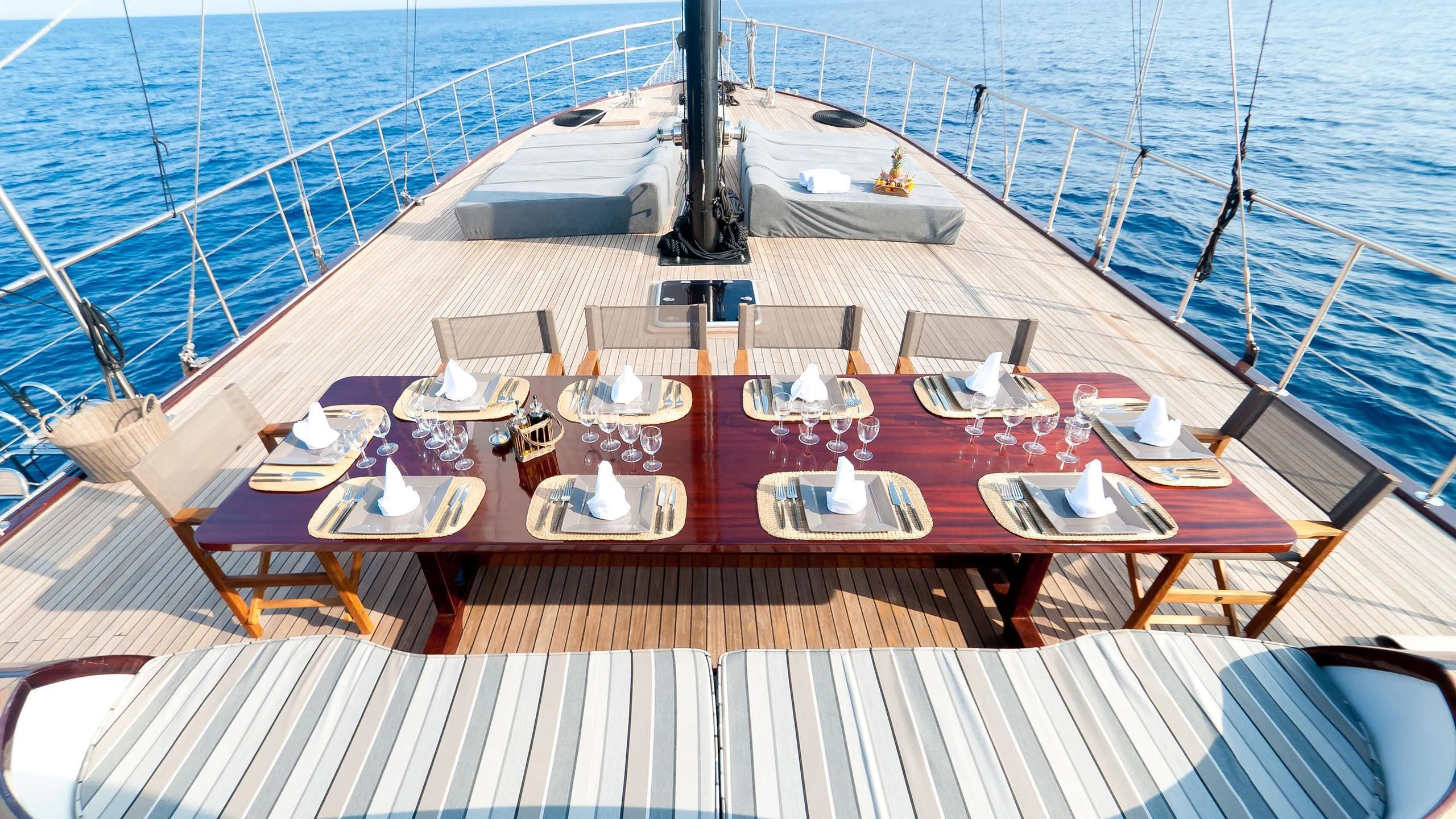 a deck with a table and chairs on it aboard VITA DOLCE Yacht for Sale