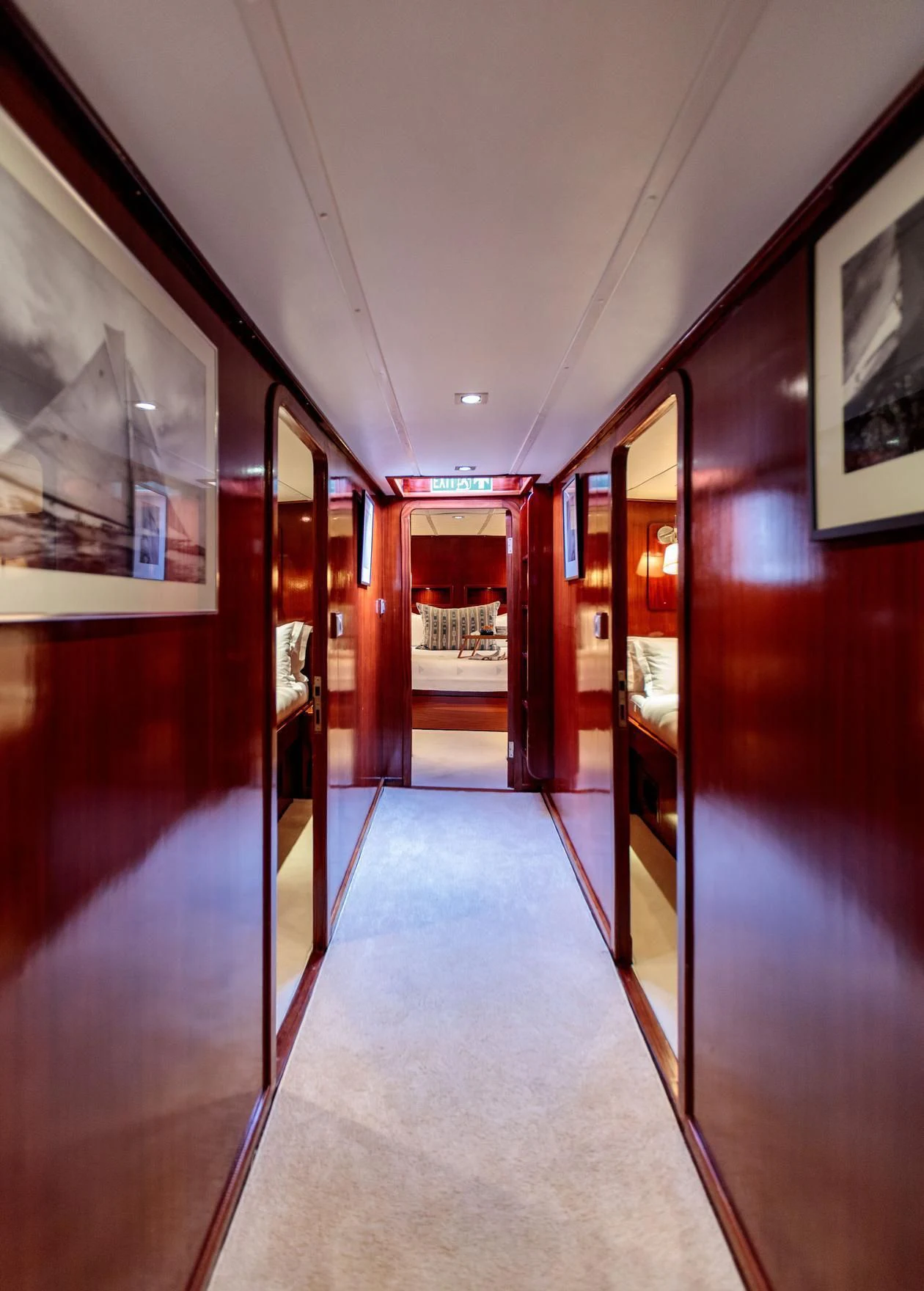a hallway with red doors aboard VITA DOLCE Yacht for Sale