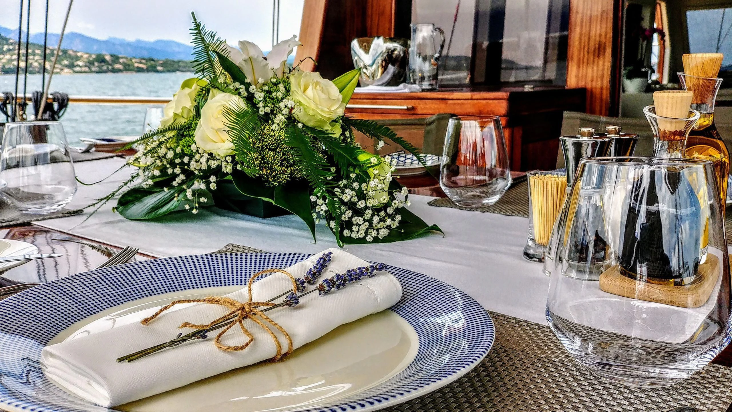 a table with a plate and glasses aboard VITA DOLCE Yacht for Sale
