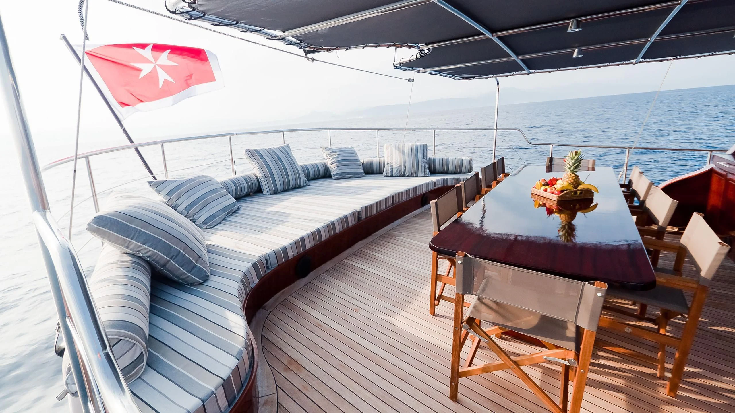 a boat with a table and chairs on it aboard VITA DOLCE Yacht for Sale
