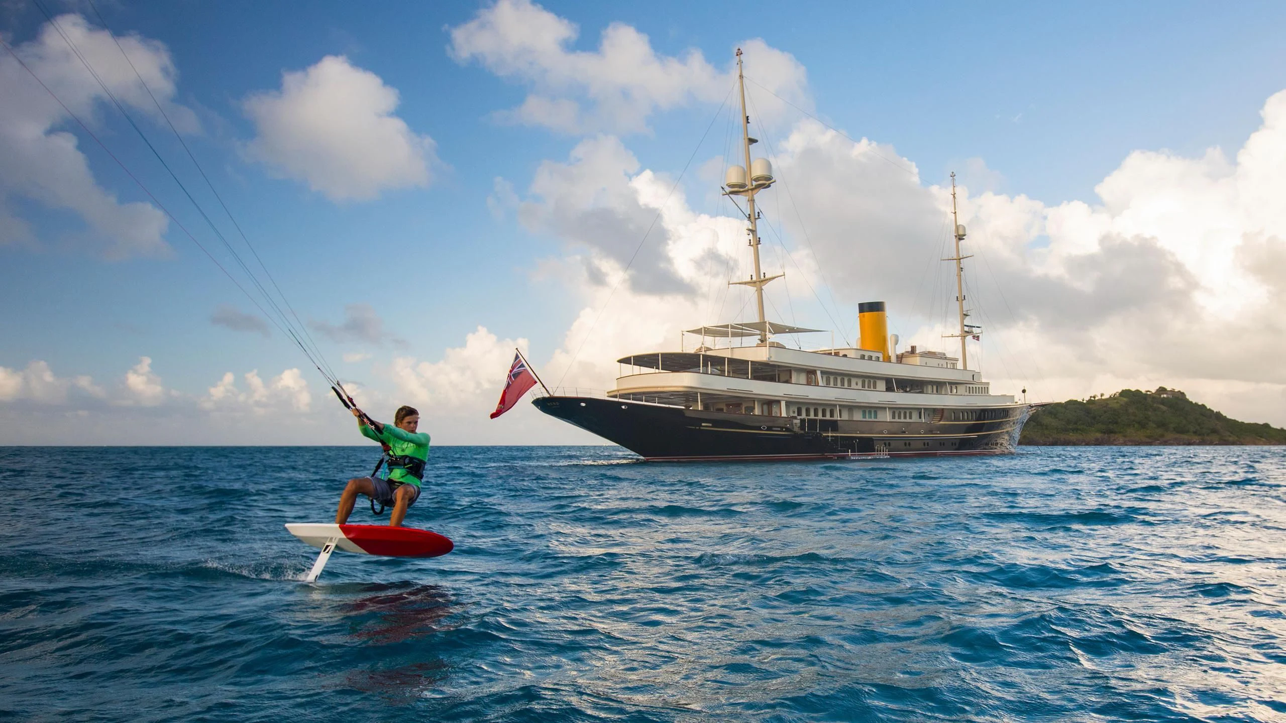 a person on a surfboard next to a large ship aboard NERO Yacht for Sale