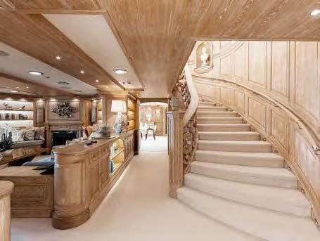 a large room with wooden stairs aboard NERO Yacht for Sale