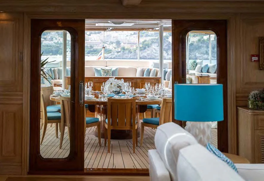 a room with a table and chairs aboard NERO Yacht for Sale