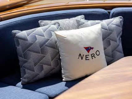 a white pillow on a couch aboard NERO Yacht for Sale