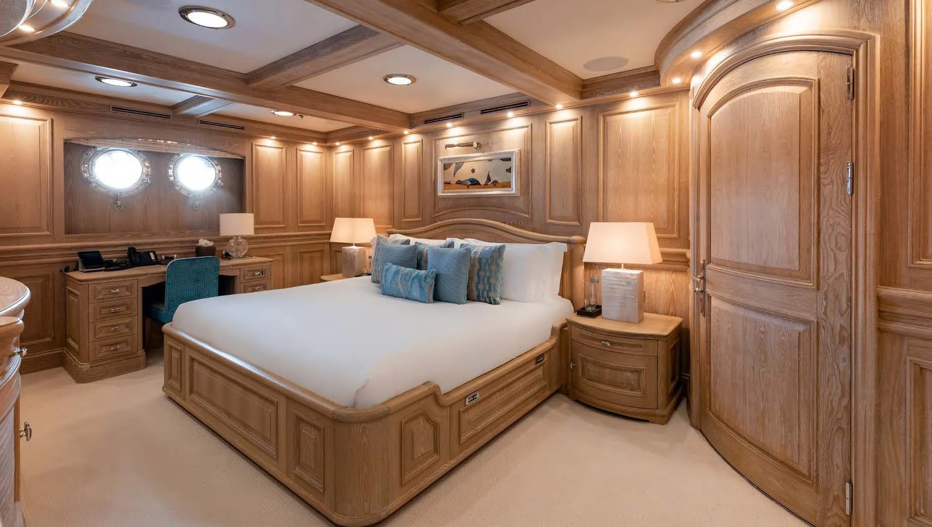 a large bedroom with a bed and a desk aboard NERO Yacht for Sale