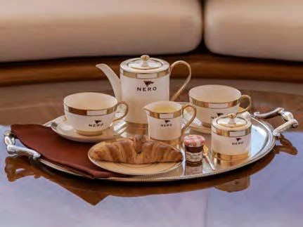a tray with a tray of food and cups on it aboard NERO Yacht for Sale