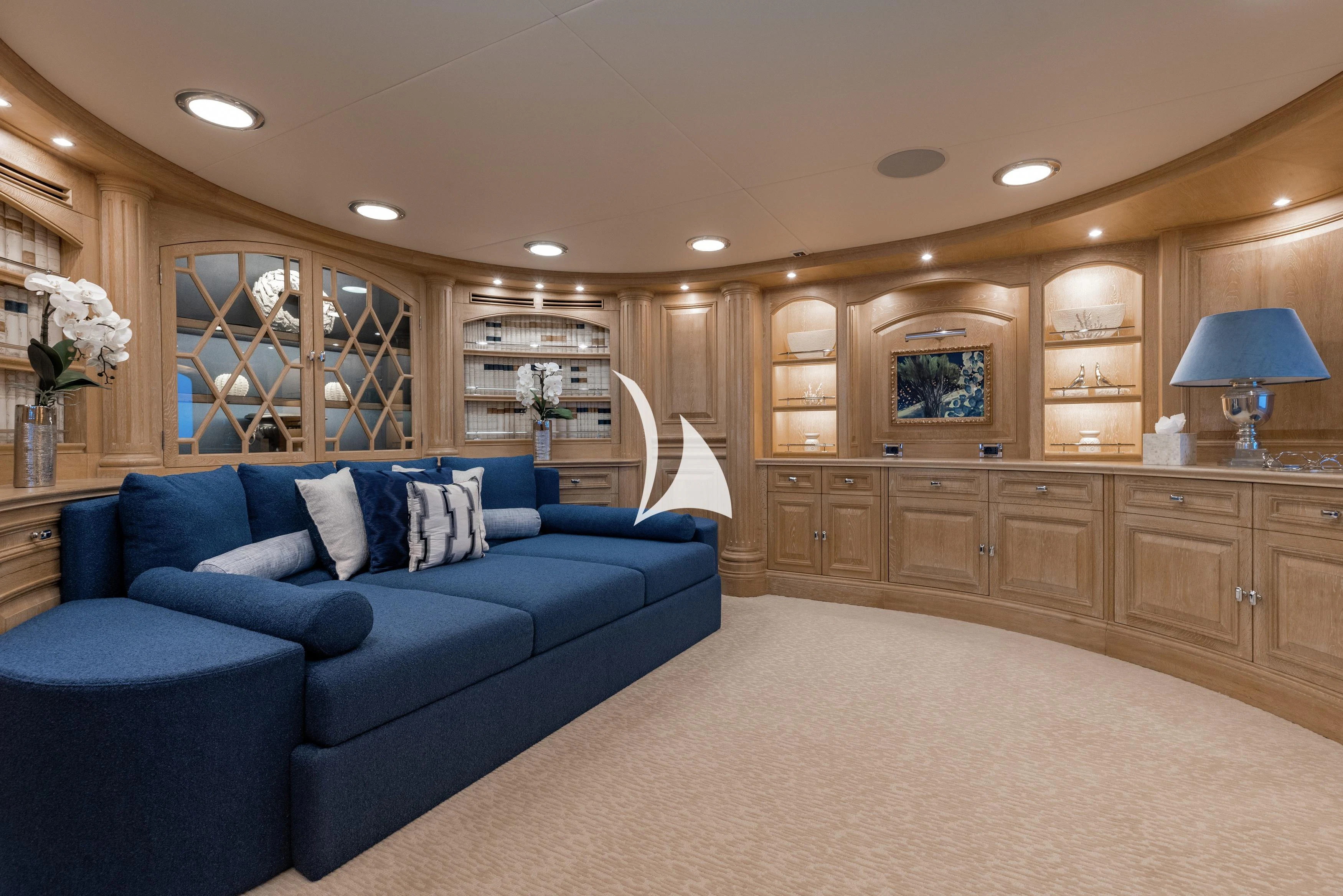 a living room with a blue couch aboard NERO Yacht for Sale