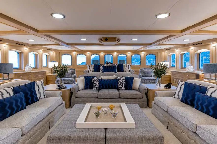 a living room with a couch and a table aboard NERO Yacht for Sale