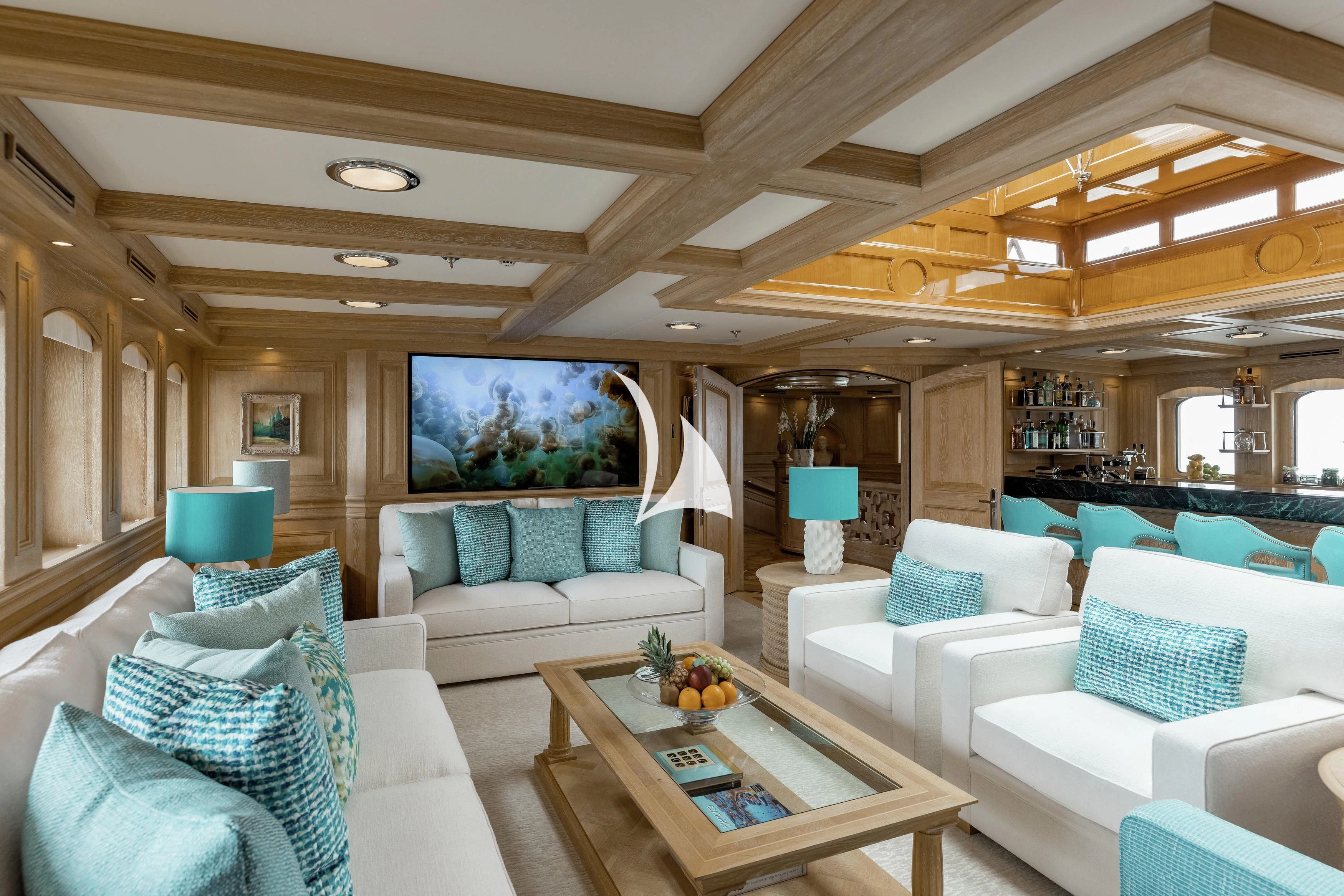 a living room with a large sofa and a table aboard NERO Yacht for Sale