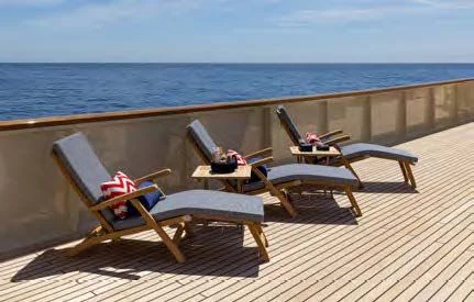 chairs and tables on a deck overlooking the ocean aboard NERO Yacht for Sale
