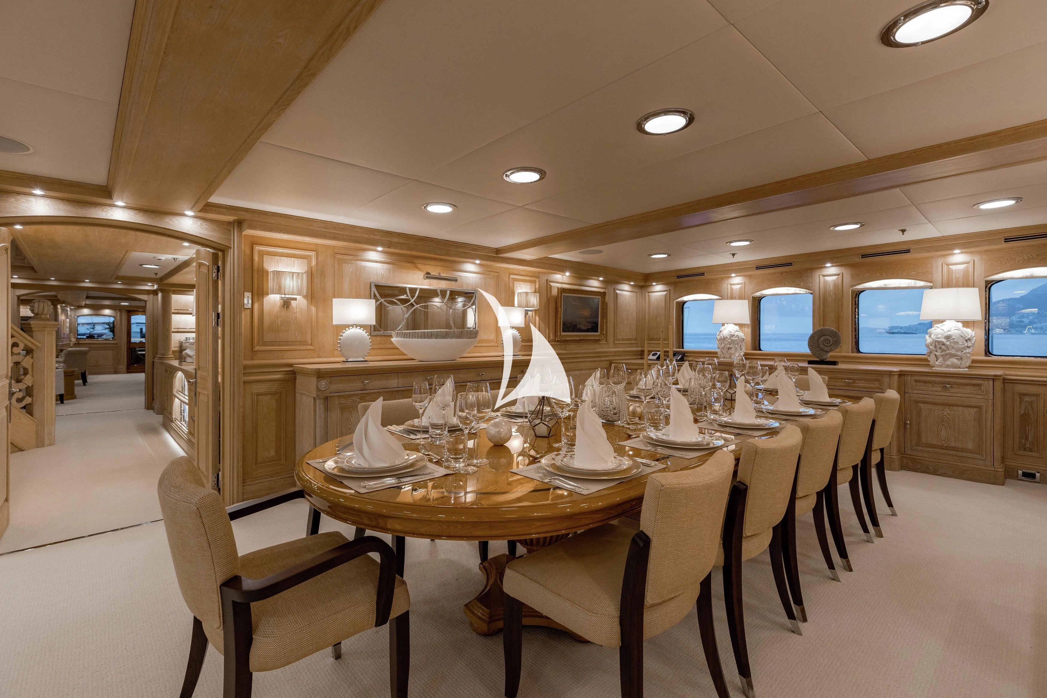 a large kitchen with a table and chairs aboard NERO Yacht for Sale