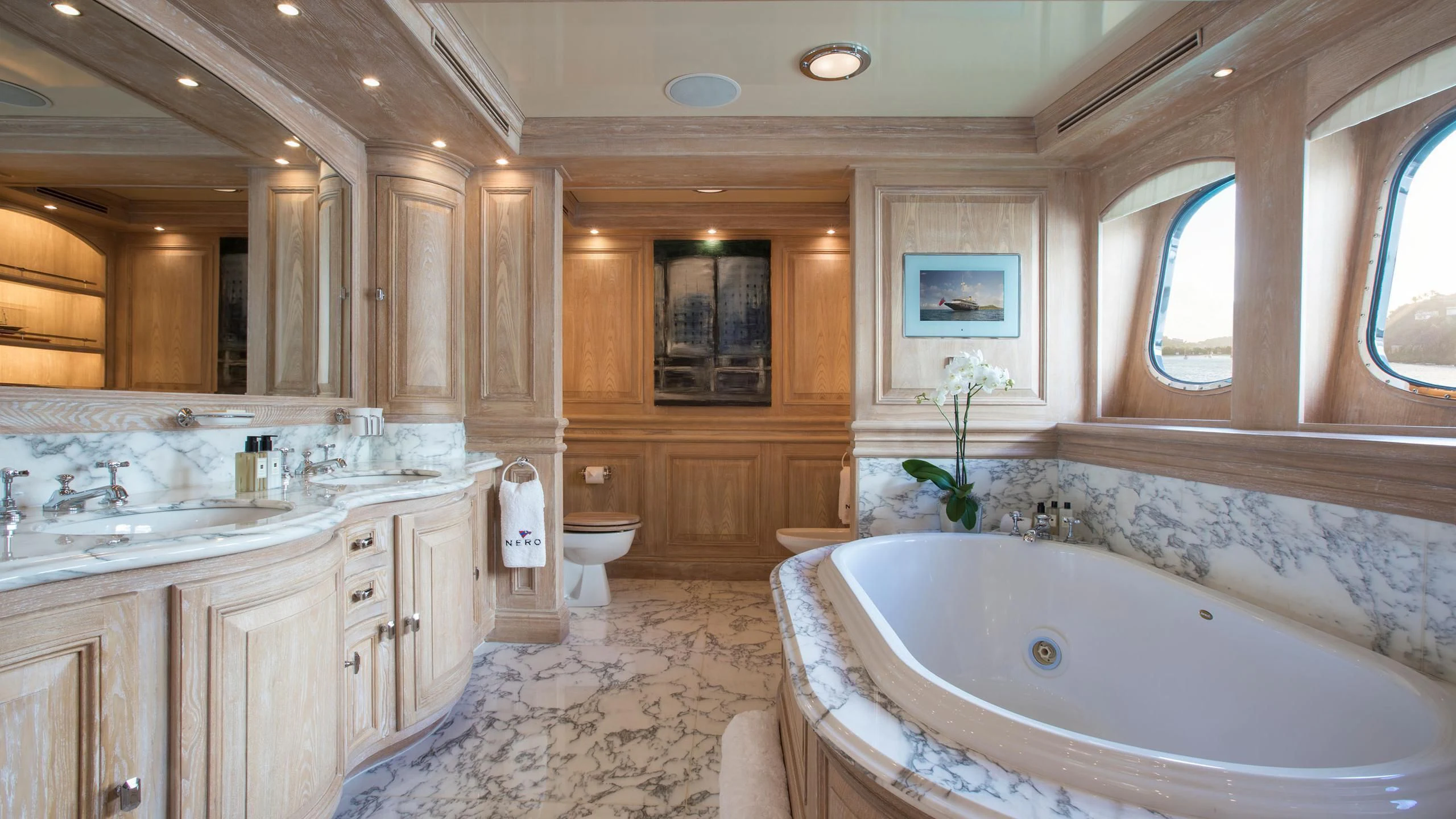 a bathroom with a tub sink and toilet aboard NERO Yacht for Sale