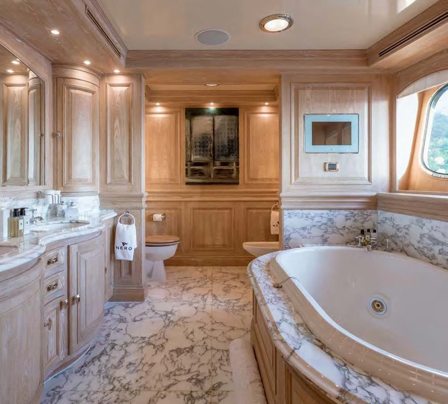 a bathroom with a tub sink and toilet aboard NERO Yacht for Sale