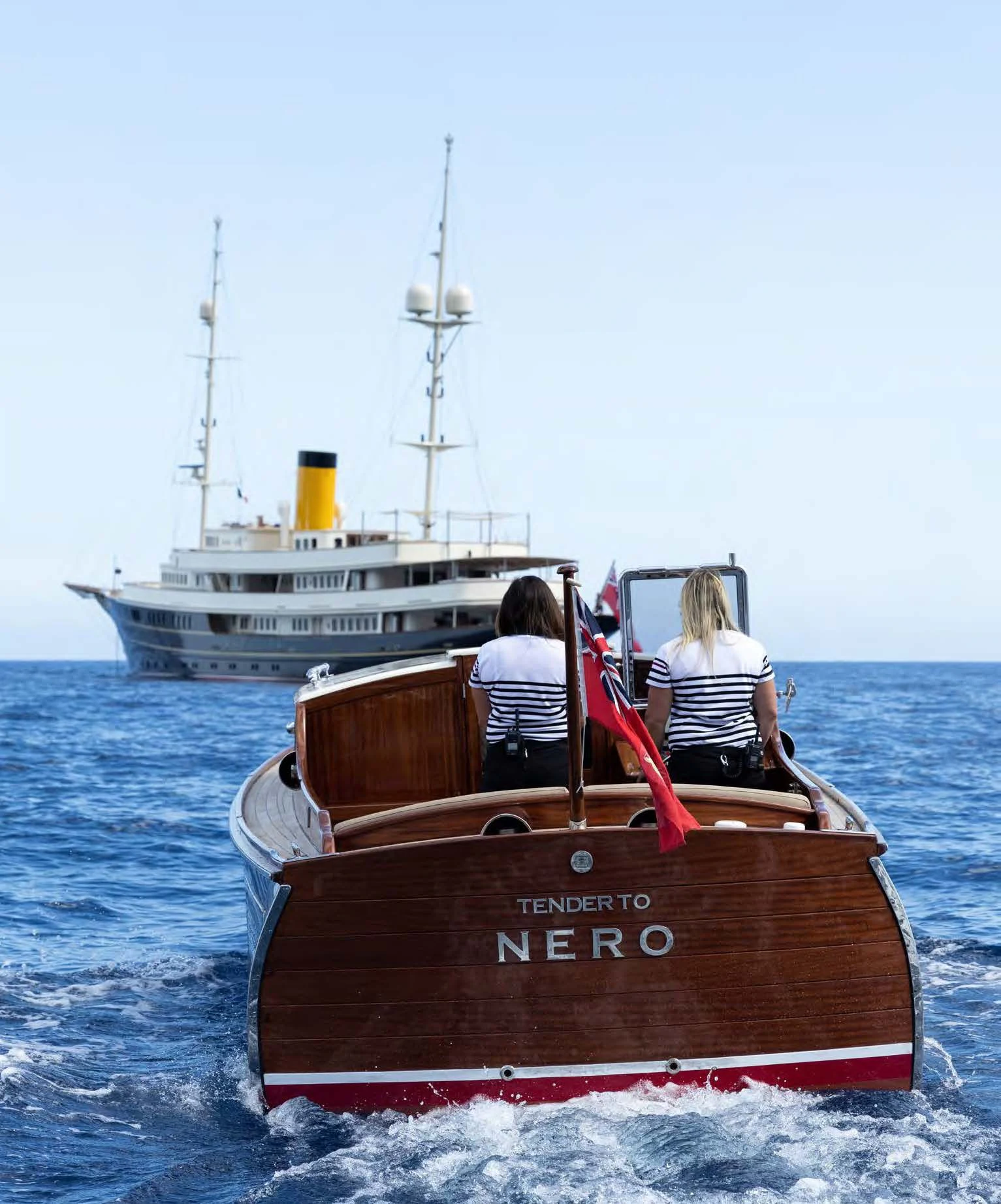a couple of people sitting on a boat in the water aboard NERO Yacht for Sale