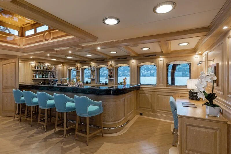 a bar with a bar and seating area aboard NERO Yacht for Sale