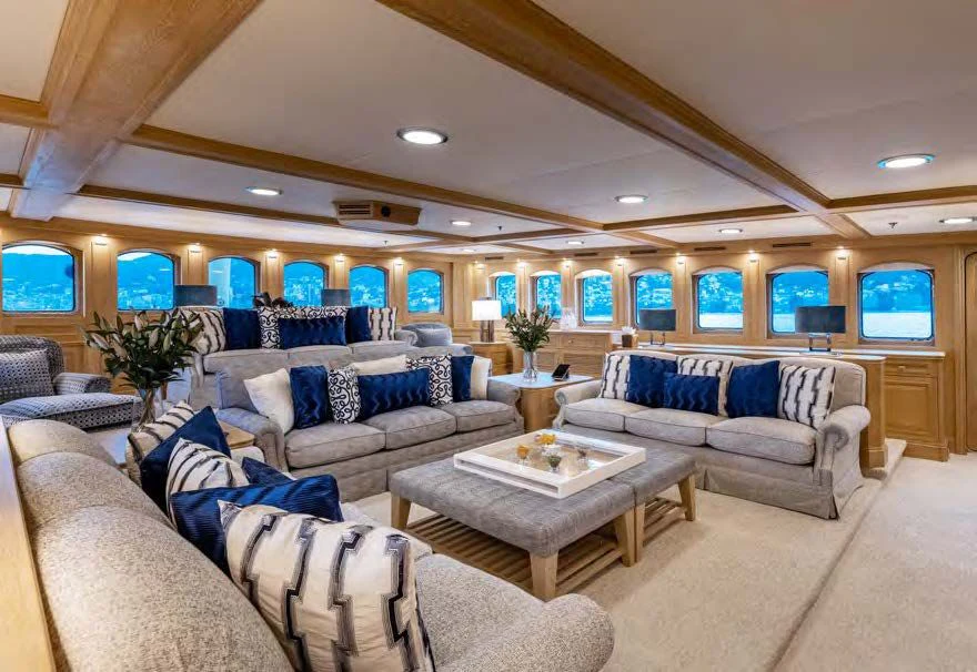 a living room with couches and a coffee table aboard NERO Yacht for Sale