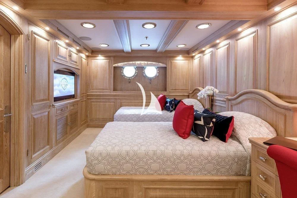 a bedroom with a bed and a television aboard NERO Yacht for Sale