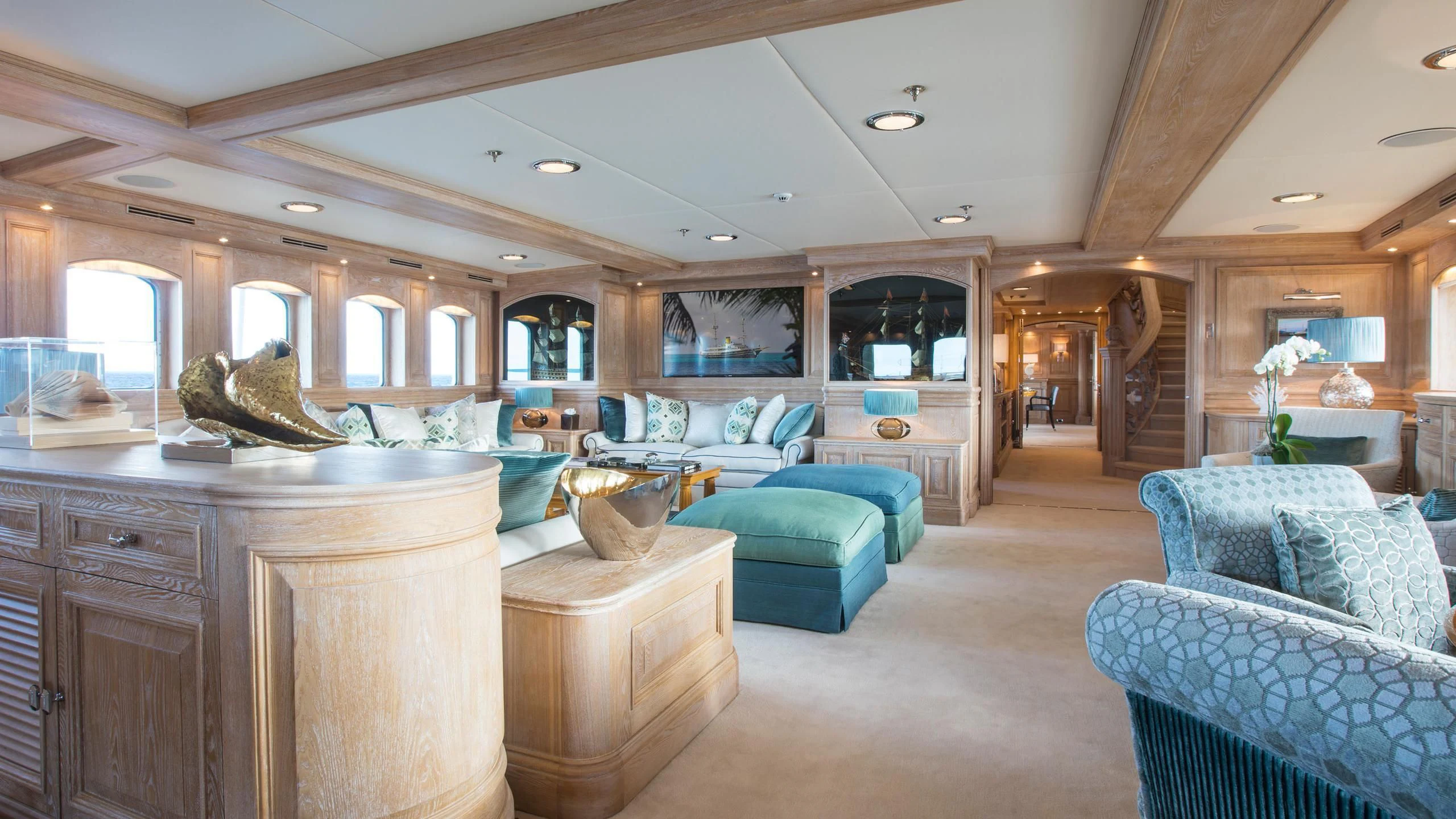 a large living room with a large wood table and chairs aboard NERO Yacht for Sale
