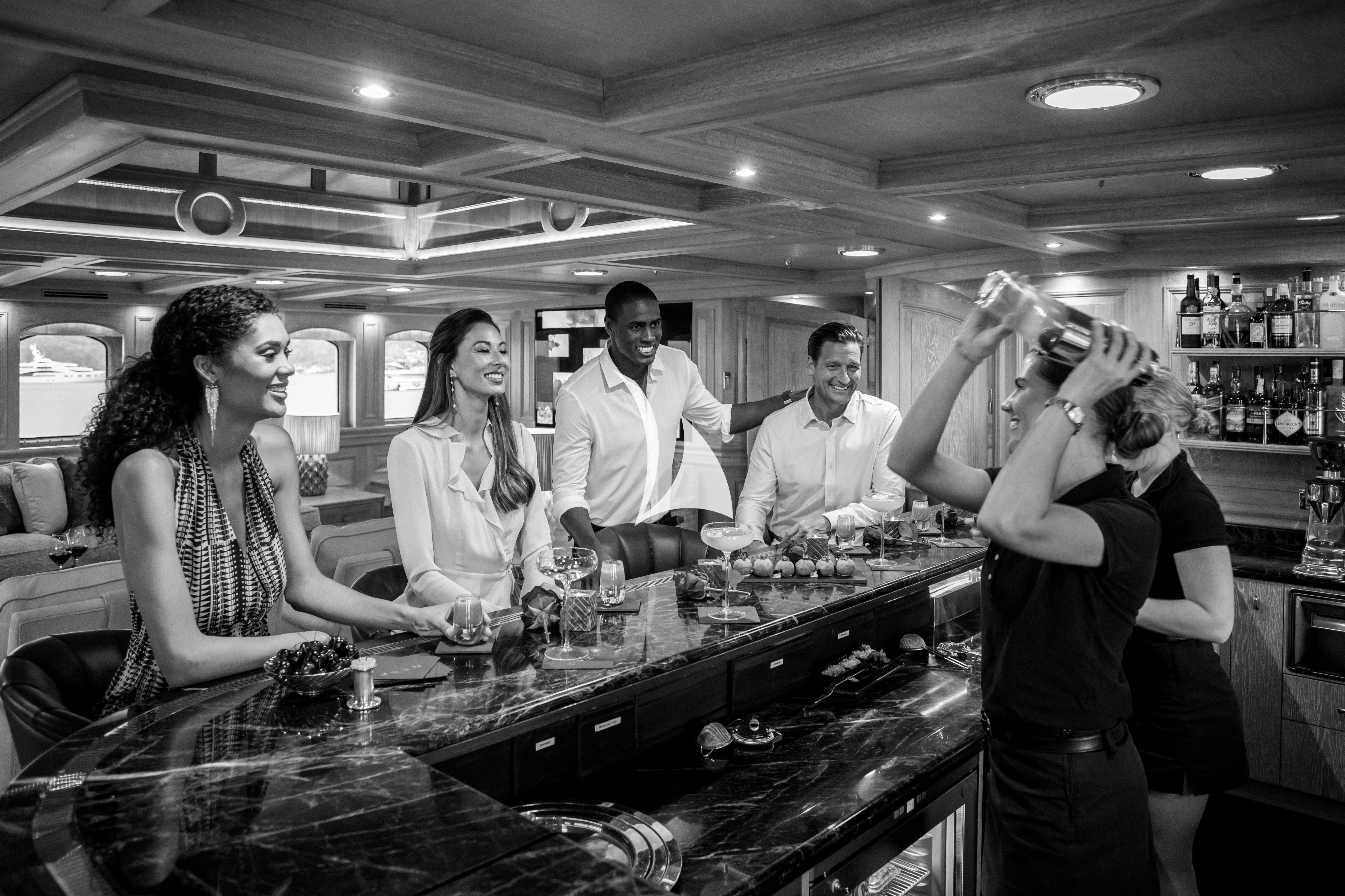 a group of people in a bar aboard NERO Yacht for Sale