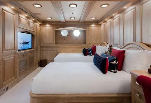 a room with a bed and a television aboard NERO Yacht for Sale