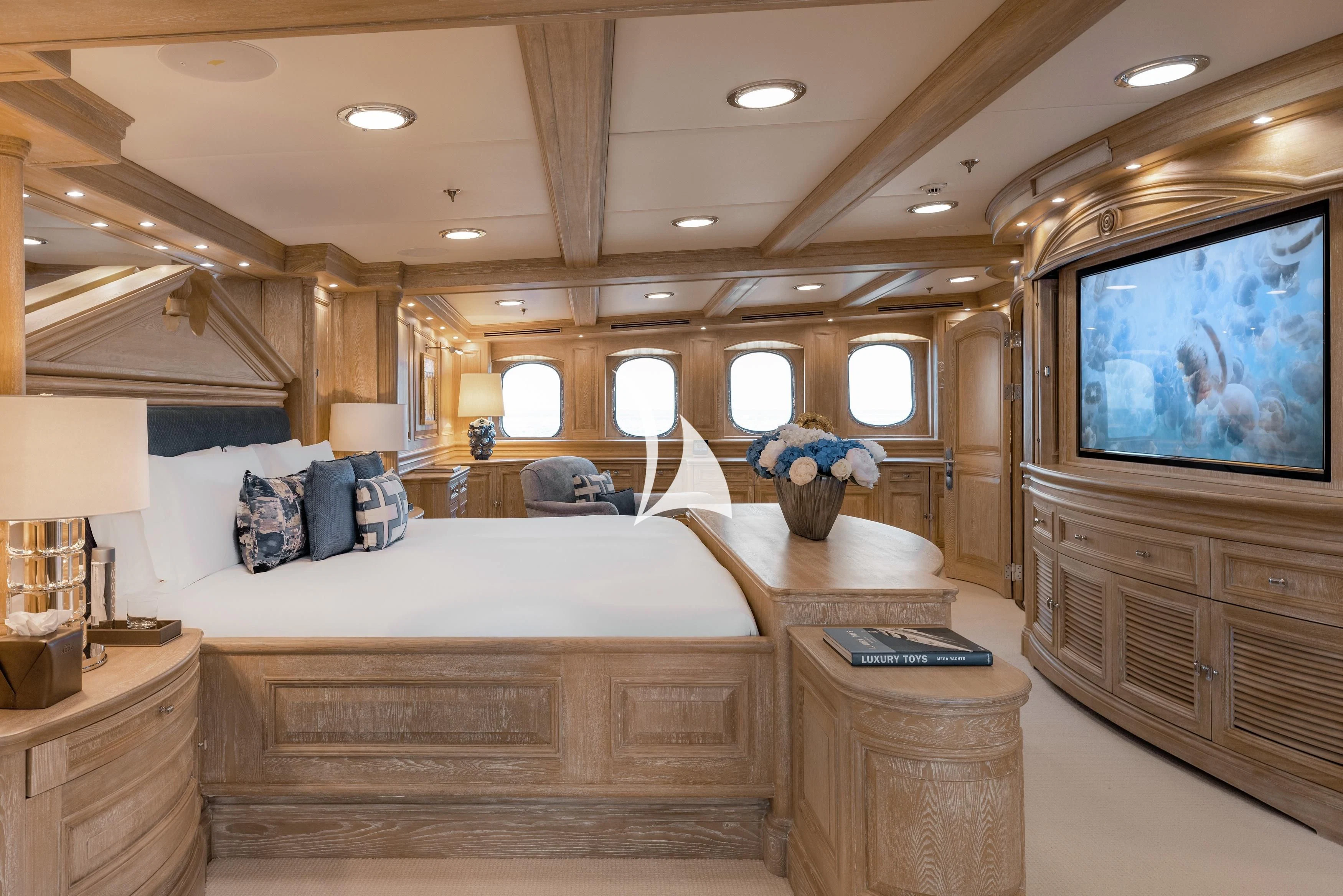a room with a large television and a bed aboard NERO Yacht for Sale