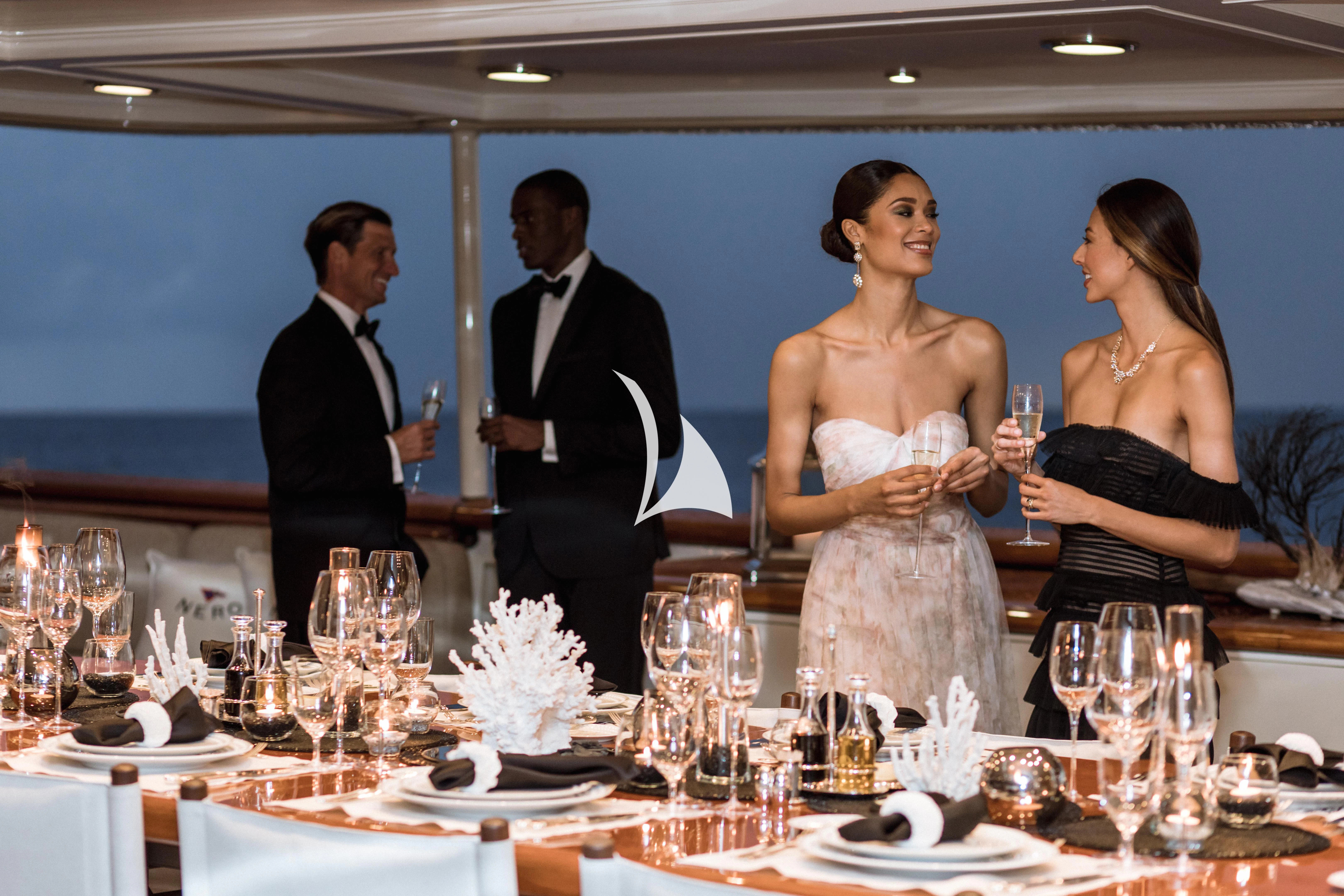 a group of people at a dinner table aboard NERO Yacht for Sale