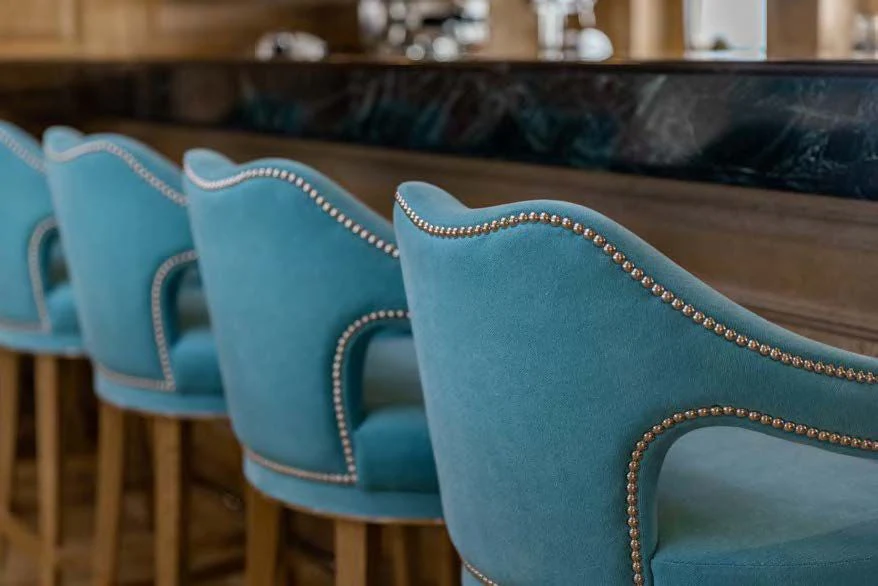 a pair of blue chairs aboard NERO Yacht for Sale