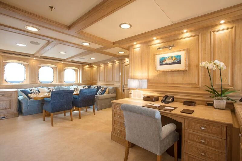 a large living room with a desk aboard NERO Yacht for Sale