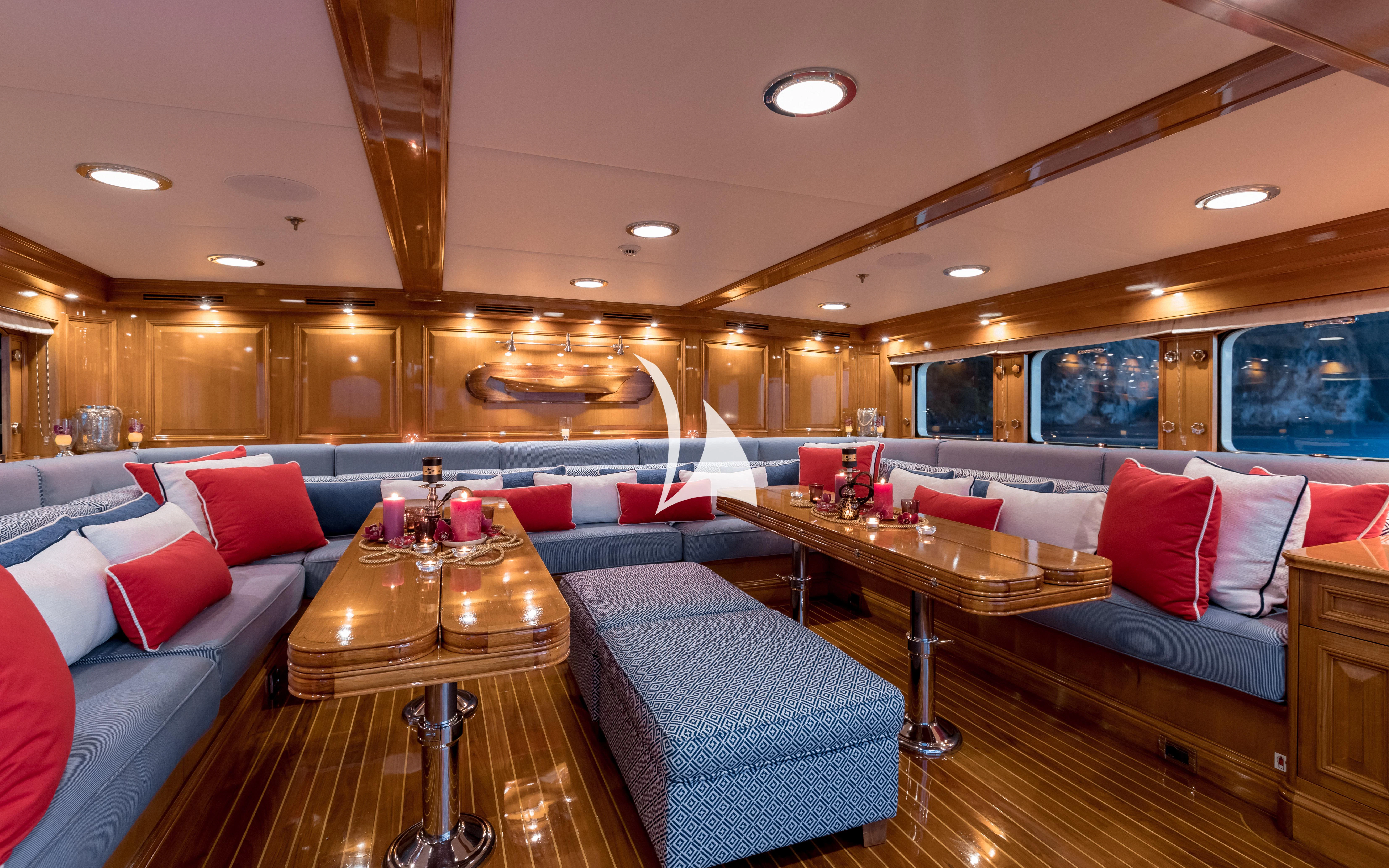 a living room with a couch and a table aboard NERO Yacht for Sale