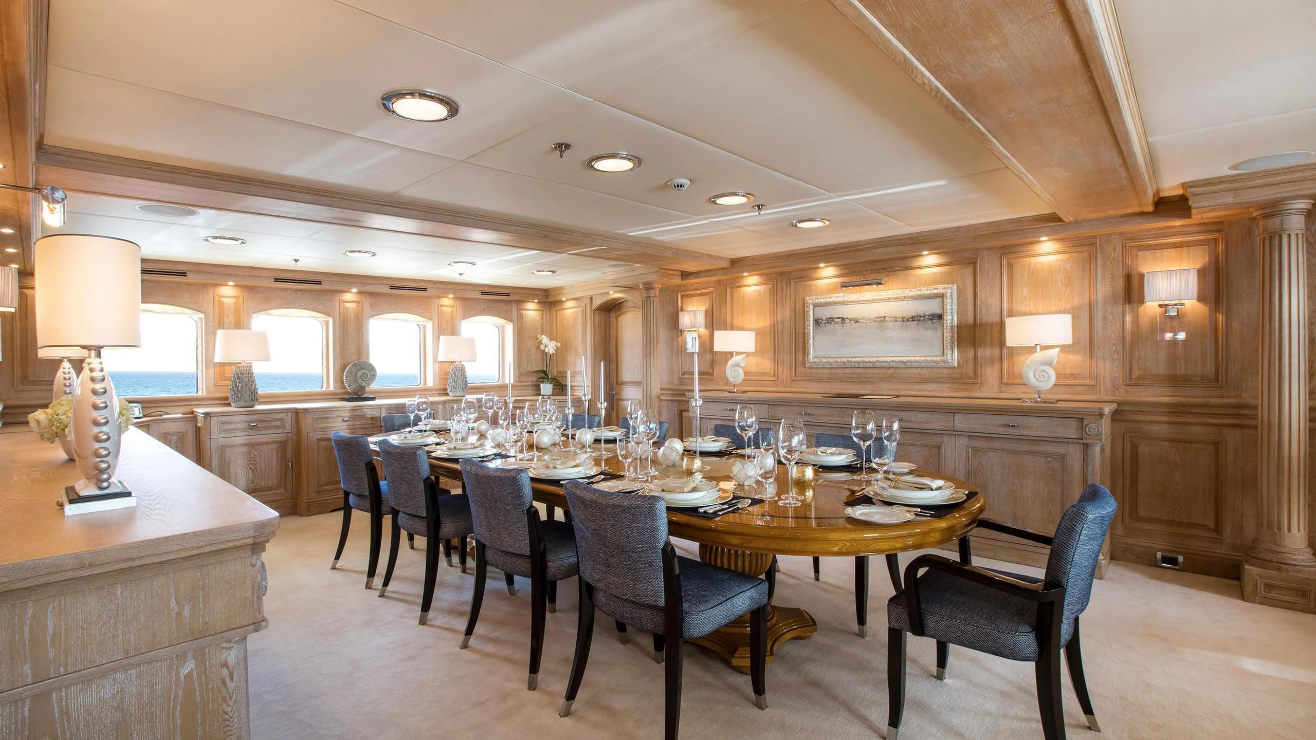 a large room with a table and chairs aboard NERO Yacht for Sale