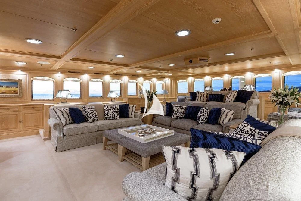 a living room with couches and a coffee table aboard NERO Yacht for Sale