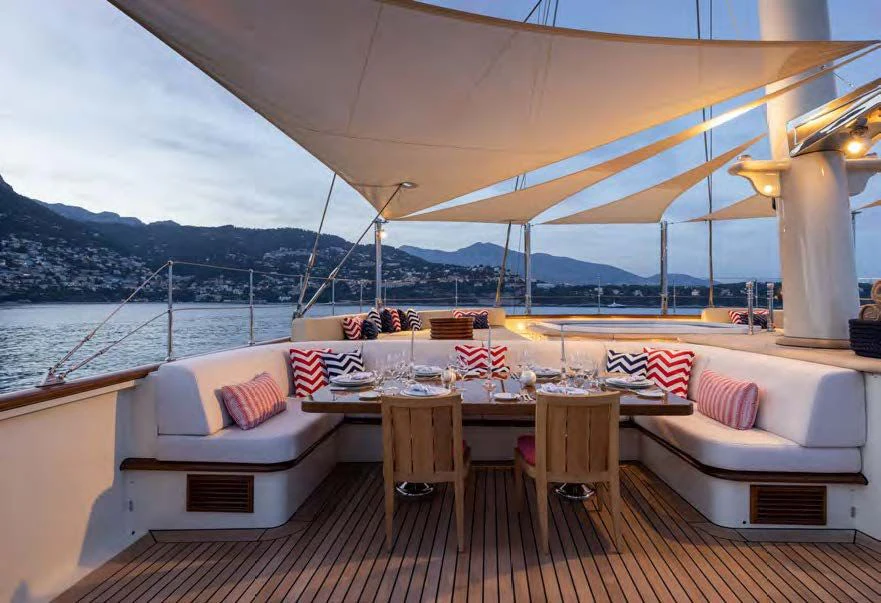 a table and chairs on a boat aboard NERO Yacht for Sale