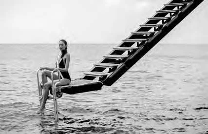a person sitting on a chair in the water aboard NERO Yacht for Sale