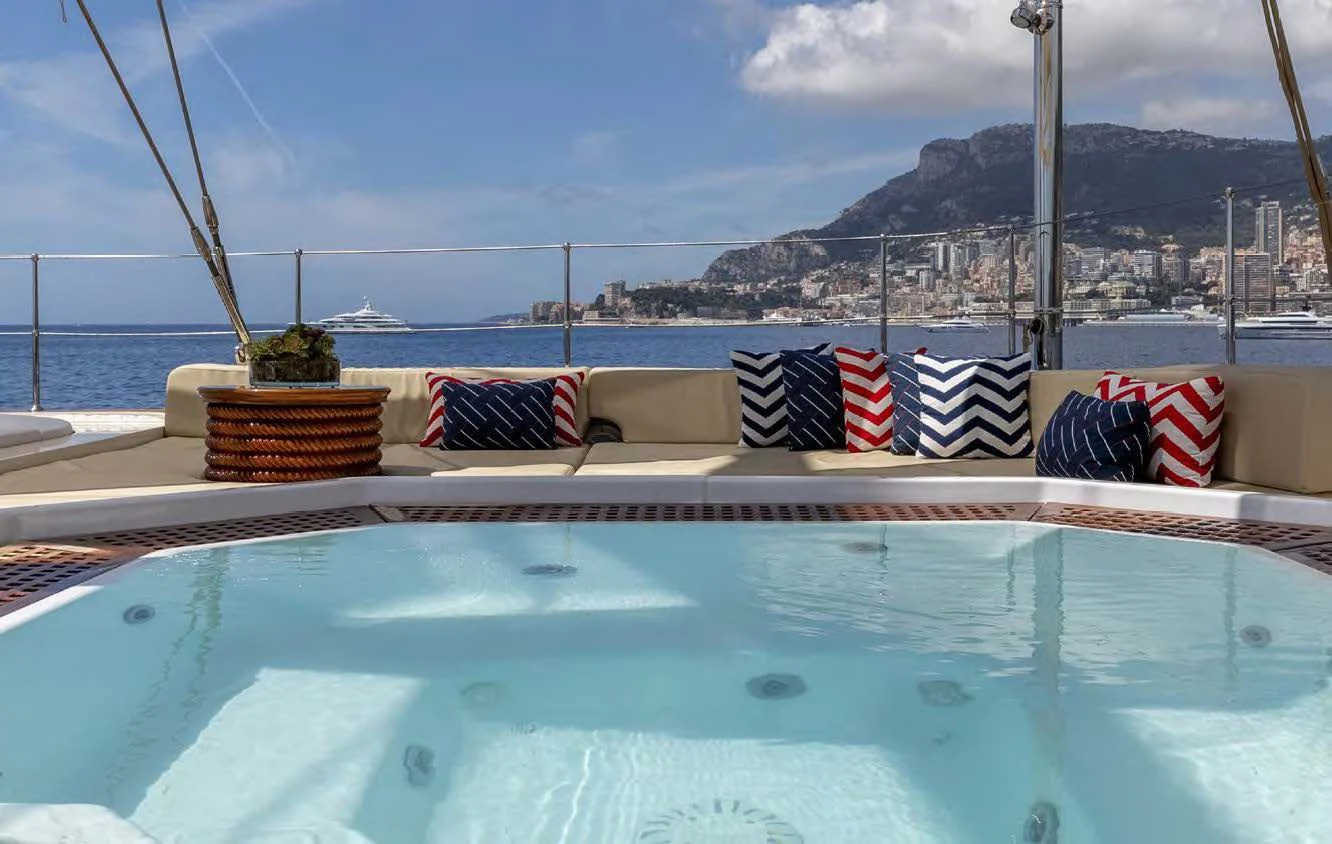 a swimming pool with flags aboard NERO Yacht for Sale