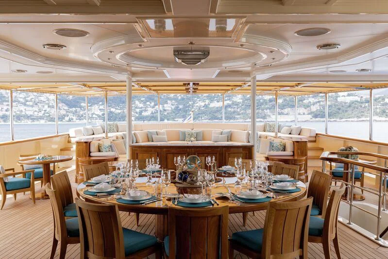 a room with tables and chairs aboard NERO Yacht for Sale
