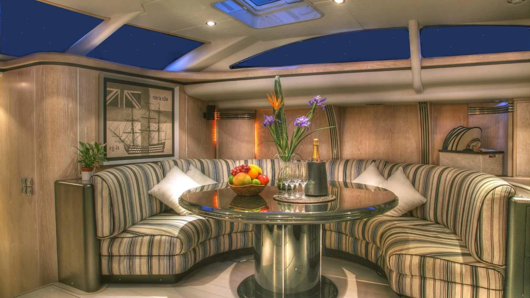 a living room with a table and couches aboard MARIA ALBA II Yacht for Sale