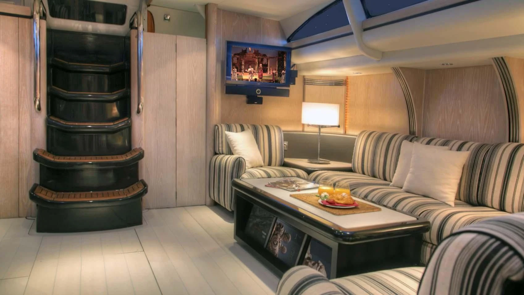 a living room with a couch and a television aboard MARIA ALBA II Yacht for Sale