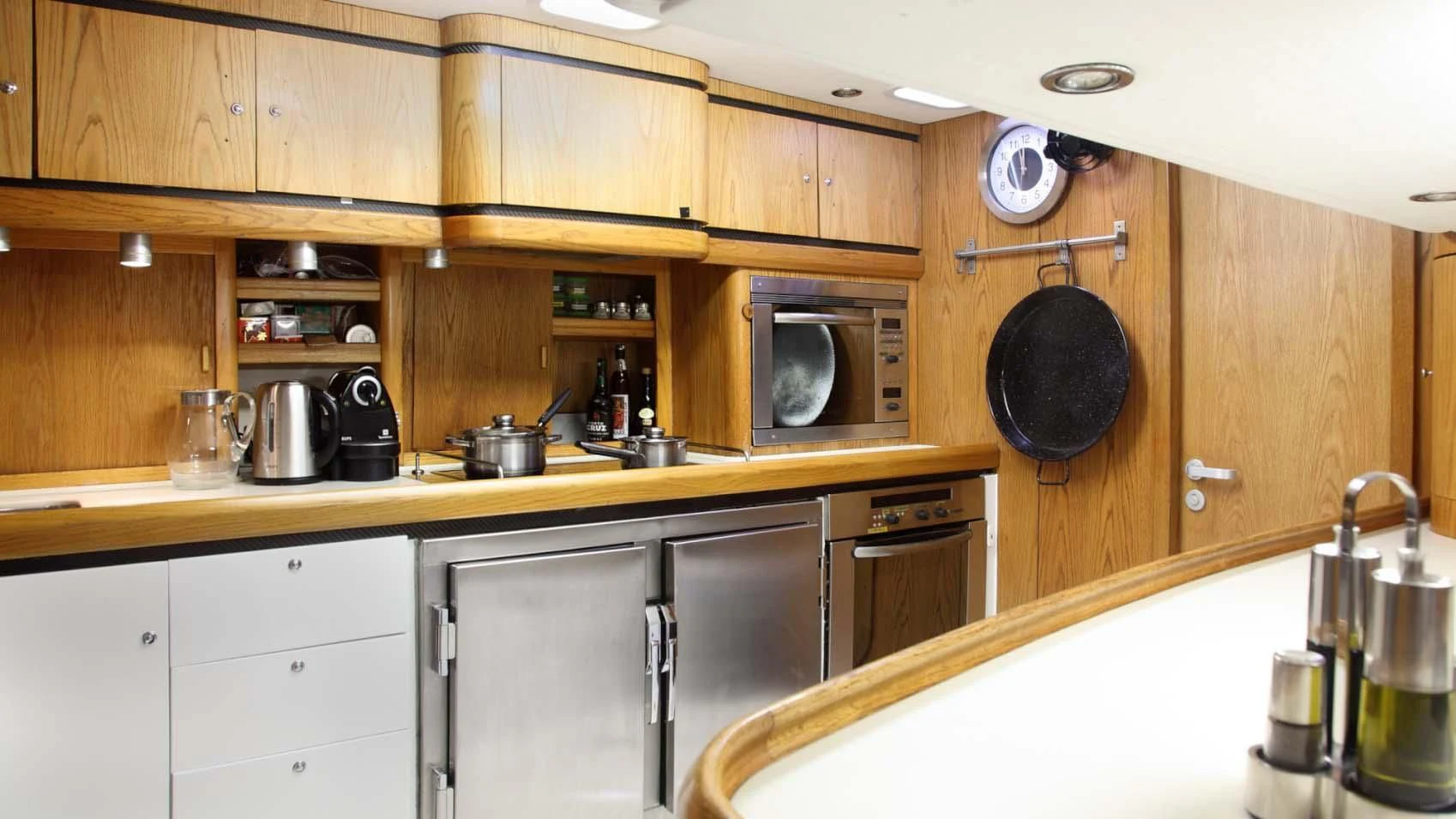 a kitchen with wooden cabinets aboard MARIA ALBA II Yacht for Sale