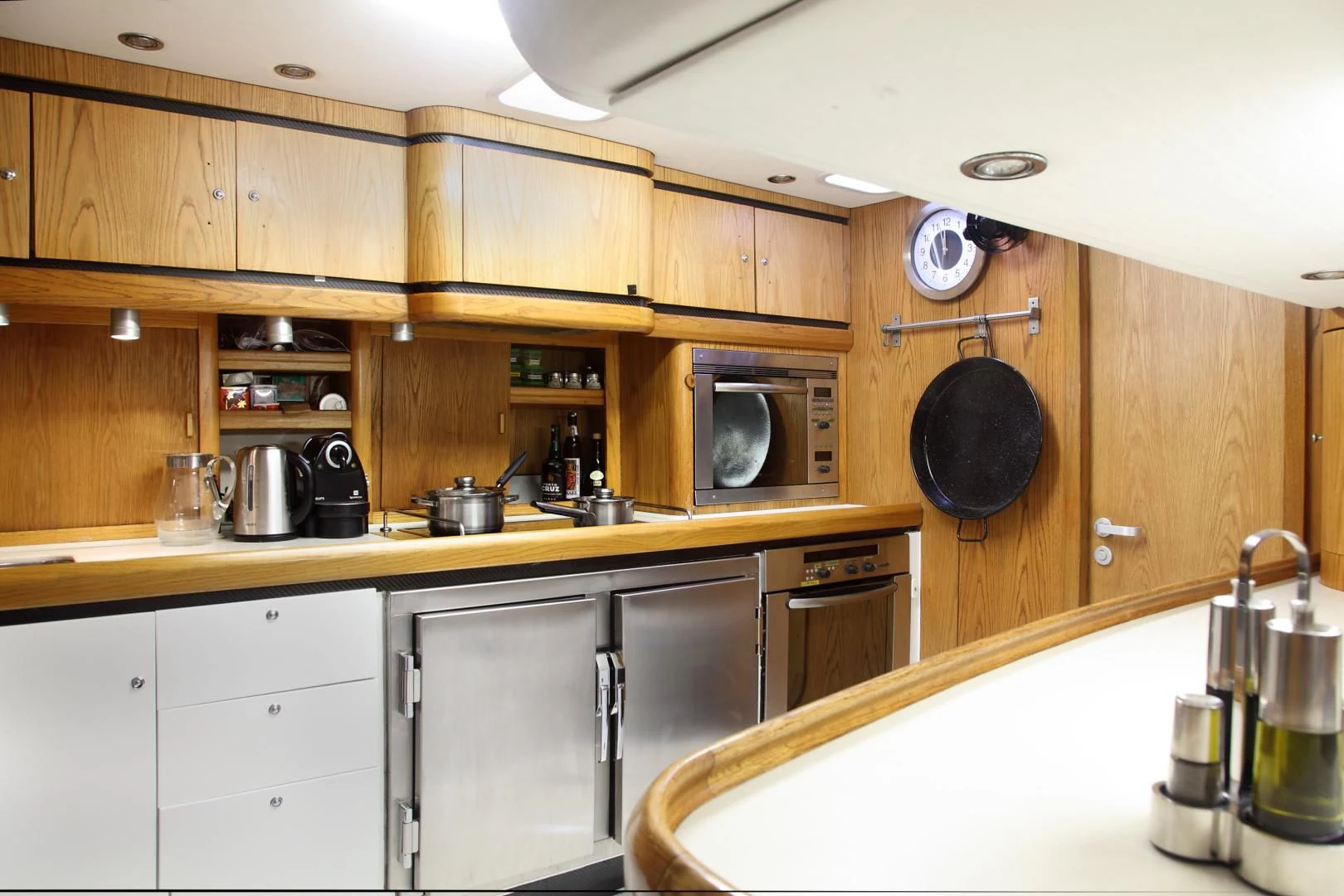 a kitchen with wooden cabinets aboard MARIA ALBA II Yacht for Sale