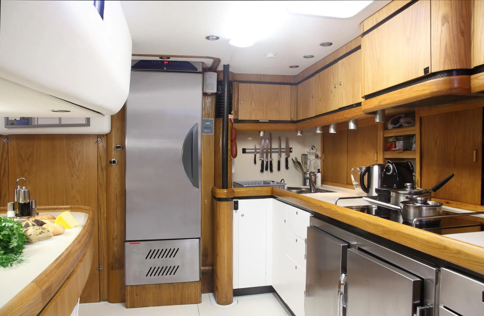 a kitchen with a fridge and a sink aboard MARIA ALBA II Yacht for Sale